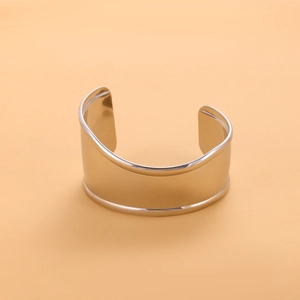 Macro shot of silver wide open cuff bracelet with a polished mirror finish surface