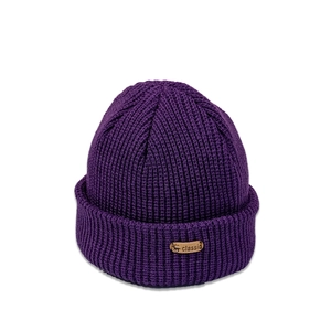 Close-up of purple ribbed knit beanie showing deer logo patch and thick texture details