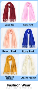 Close-up of fringe details on soft scarves in burgundy, pink, blue, and yellow