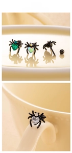 Macro detail of black spider ear stud with heart zircon and threaded screw ball back