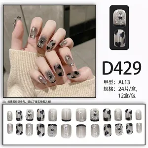 Black translucent press-on nails featuring cute 3D bear, heart motifs, and glitter accents