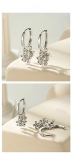 Macro detail of silver earrings with floral pendants and micro-pave cubic zirconia