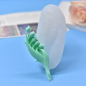 Lily of the valley silicone mold with finished resin flower on a blue background