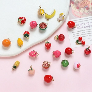 Flat lay of colorful fruit charms like strawberry and watermelon for DIY jewelry making
