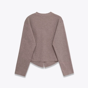 Detailed back view of a soft ribbed knit sweater featuring an irregular layered hem