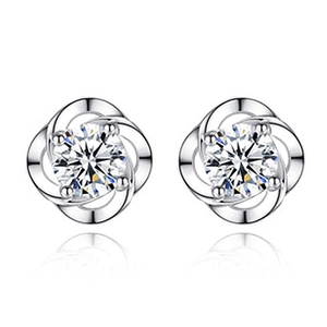 Macro detail of silver sterling earrings with sparkling cubic zirconia in petal setting