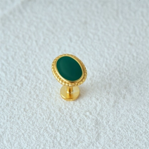 Macro view of golden S925 silver stud earring with green oval opal and textured edges