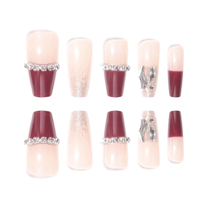 Press-on nail set featuring burgundy and nude pink tones with rhinestones and silver accents