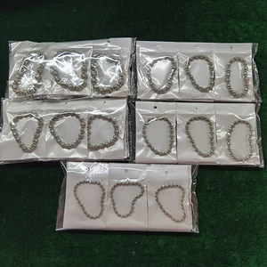 Detail of bulk silver stainless steel beaded bracelets in individual clear packaging