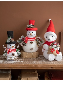 Detailed view of white foam polar bear and snowman figurines with festive red scarves