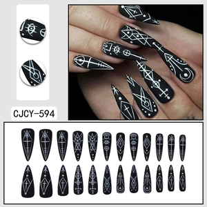 Gothic long stiletto press-on nails with black matte finish and mystical occult symbols