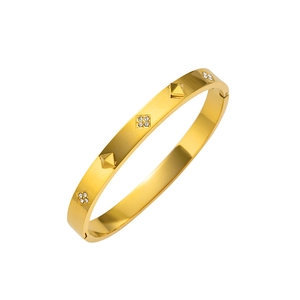 Polished gold stainless steel bangle with pyramid studs and pavé crystal accents