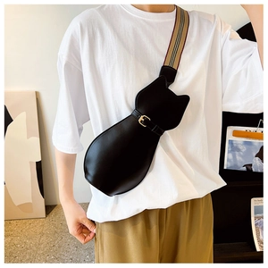 Detail of a cat-shaped crossbody bag with a matte black finish and a signature plaid strap