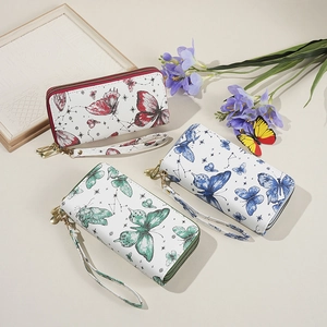 Set of three long zip-around wallets with colorful butterfly prints and wrist straps