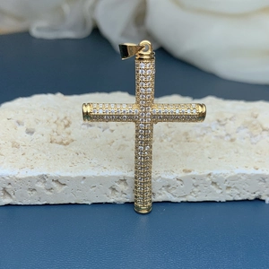 Detailed macro view of 18k gold plated cross pendant with sparkling zircon stones
