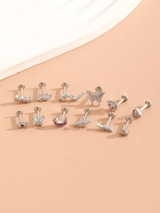 Macro shot of 12-piece silver earring set with butterfly, moon, and heart zircon charms