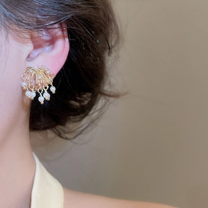 Detailed macro view of 18k gold plated firework earring with zircons and pearls