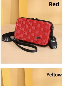 Detail of red PC hard shell crossbody bag with quilted pattern and logo strap