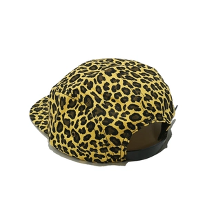 Detail of 5-panel leopard print cap with adjustable black strap and metal eyelets