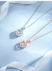 Detail of S925 sterling silver heart pendants in silver and rose gold with pavé stones