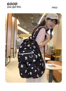 Detail of black backpack with cute white bear print and multiple zipper pockets