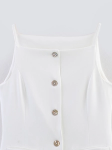 Detail of white button-down tank top showing textured fabric and shell-luster buttons