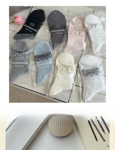 Detail of colorful cotton crew socks featuring cute ruffled lace edges and brand logo