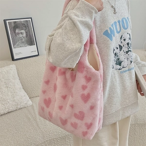 Detail of pink plush heart tote bag showing the soft faux fur texture and side profile