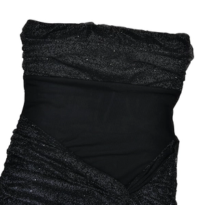 Detail of black off-shoulder dress with sparkling silver finish and pleated fabric