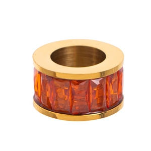 Detailed close-up of golden ring set with rectangular orange cubic zirconia stones