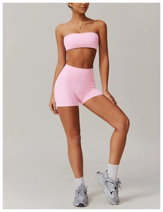 Close-up of pink high-waist fitness shorts and sports bra with elastic matte fabric