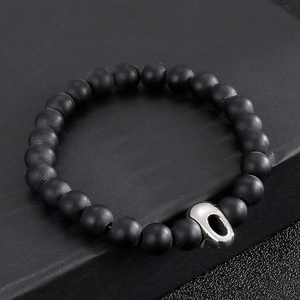 Men's matte black beaded bracelet featuring 316L stainless steel skull charm on box