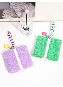 Detail of purple and green knitted plush coin purses with heart pendants and soft texture