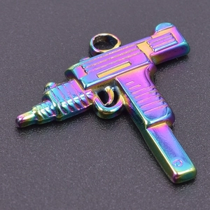 Macro detail of submachine gun pendant in colorful rainbow finish for DIY jewelry