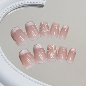Cat eye firework press-on nails in nude pink with silver French glitter tips
