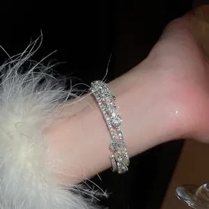 Luxurious multi-layer silver bangle with sparkling rhinestones and flower accents
