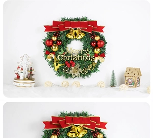 Close-up of a Christmas wreath featuring a red bow, golden bells, and Merry Christmas sign