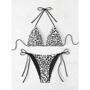 Detailed flat lay of a black and white leopard print bikini with adjustable side ties