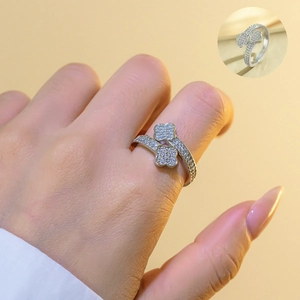 Detail of silver clover open bangle with pavé crystals on a model's wrist