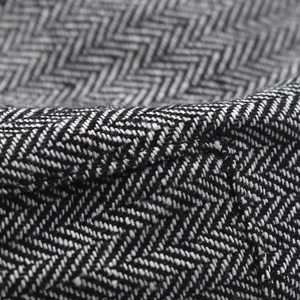Macro shot of herringbone pattern textile on a classic striped newsboy cap for men