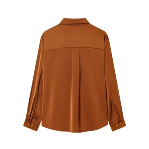 Detail of satin caramel shirt back showing yoke line and central box pleat design
