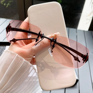 Frameless punk star sunglasses with pink gradient lenses and metal cross accents