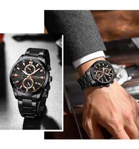 Detail of black steel chronograph watch with gold accents and wrist model view