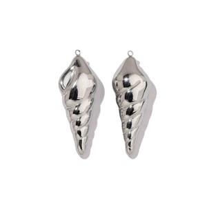 Close-up of polished stainless steel conch shell pendants for jewelry making