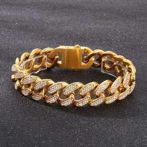 Close-up of gold Cuban link bracelet with sparkling rhinestones and heavy metal clasp