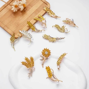Golden crystal wheat ear and sunflower brooches set with rhinestones and pearls