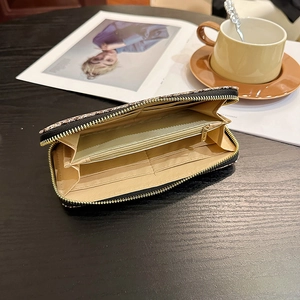 Long leopard print zipper wallet with large capacity and multi-card slots on a wooden table