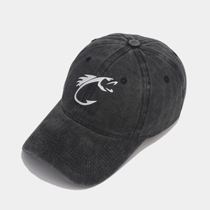 Close-up of a washed black distressed baseball cap with a white fish hook logo