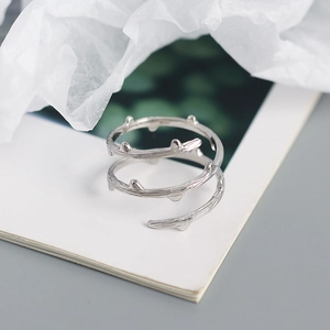 Macro shot of silver S925 sterling silver ring with organic twig texture and open design
