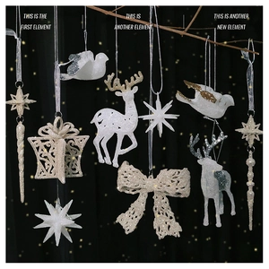 Sparkling white and champagne gold glitter Christmas ornaments on dark festive branches